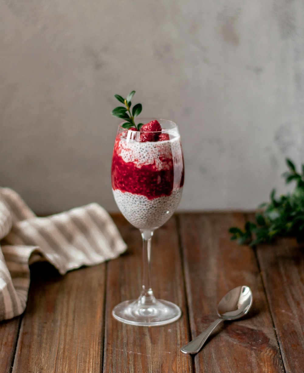 clear wine glass and gray stainless steel spoon