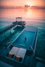 woman swimming in infinity pool at sunrise