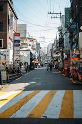 Wide view of a busy commercial district with various storefronts.