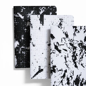 A collection of sketchbooks with different colored covers arranged artistically