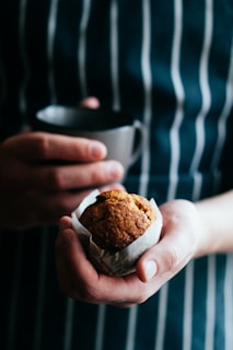 Hands holding a warm bakpia fresh from the oven with steam rising