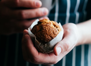 person holding a muffin