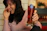 Photo of a happy customer holding a cold beer at a lively party.