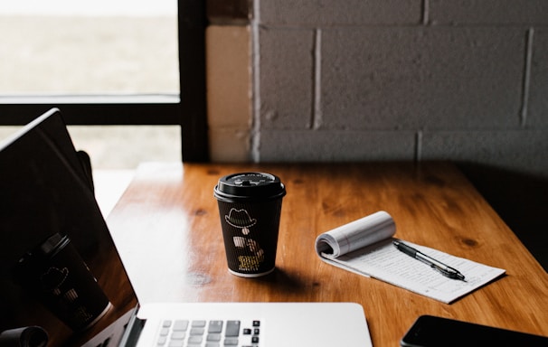 laptop on table near cup