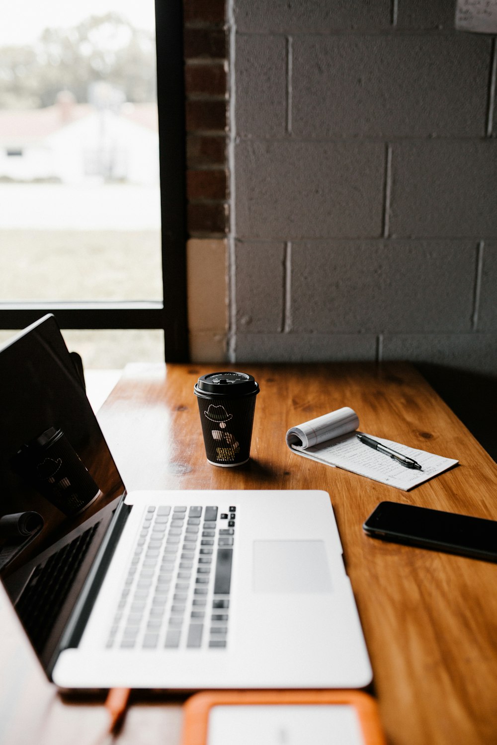 laptop on table near cup