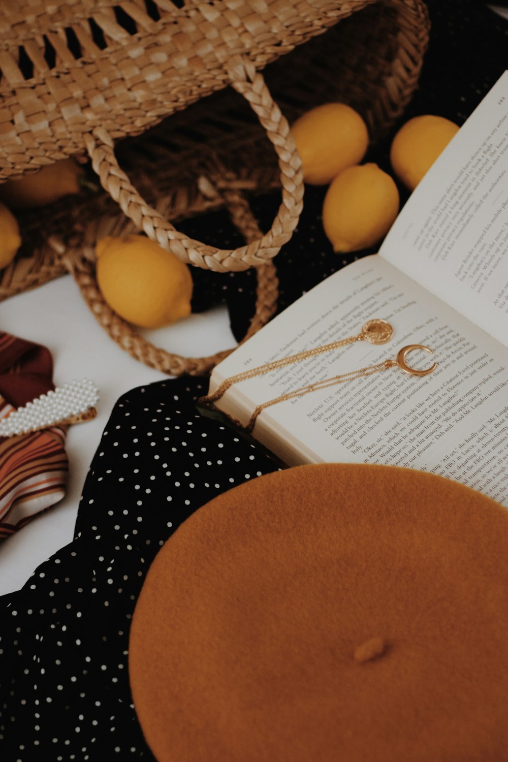 gold-colored half moon pendant necklace on opened book page