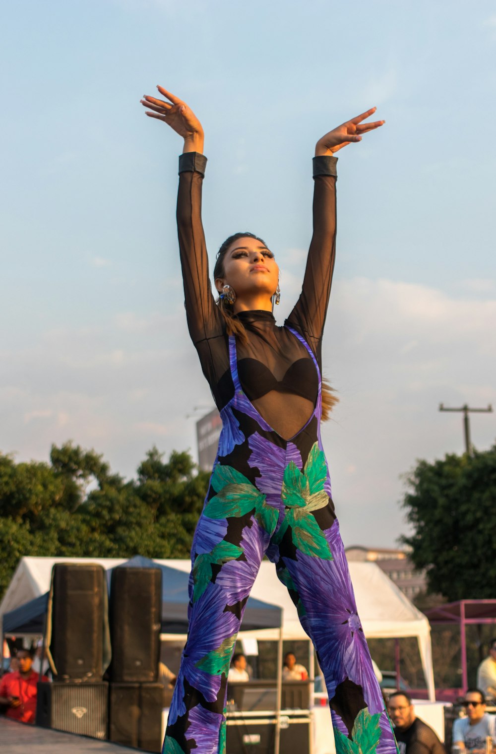 woman wearing black and purple floral jump suit