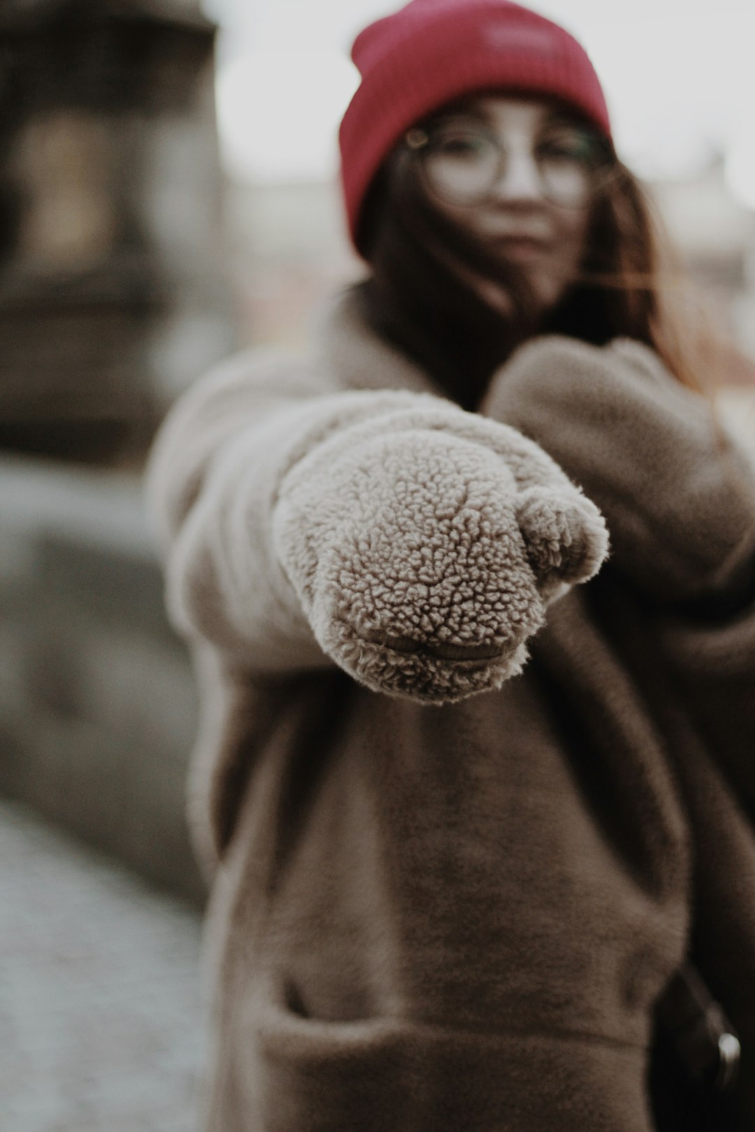 woman wearing gray sweater and red hat