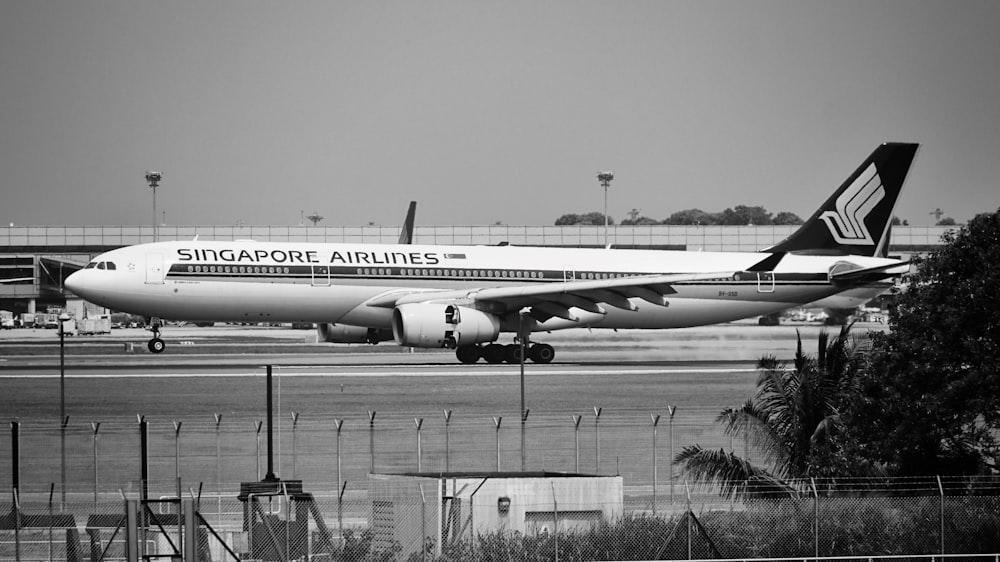 Singapore Airlines commercial airplanes in the runway grayscale photography