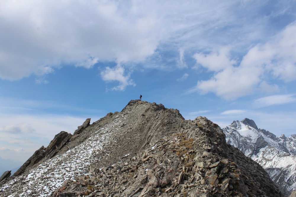 mountain under white clouds and blue sky at daytime