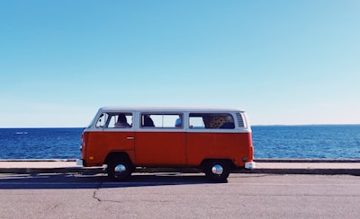 white and red van near body of water