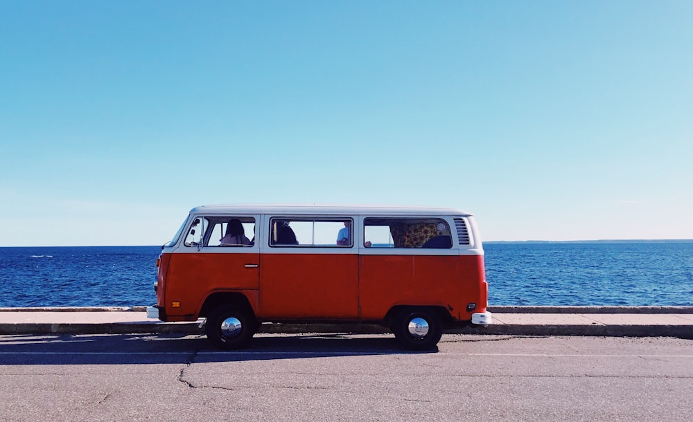 white and red van near body of water