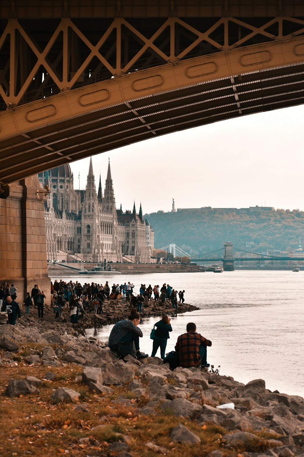 people standing under bridge during daytime