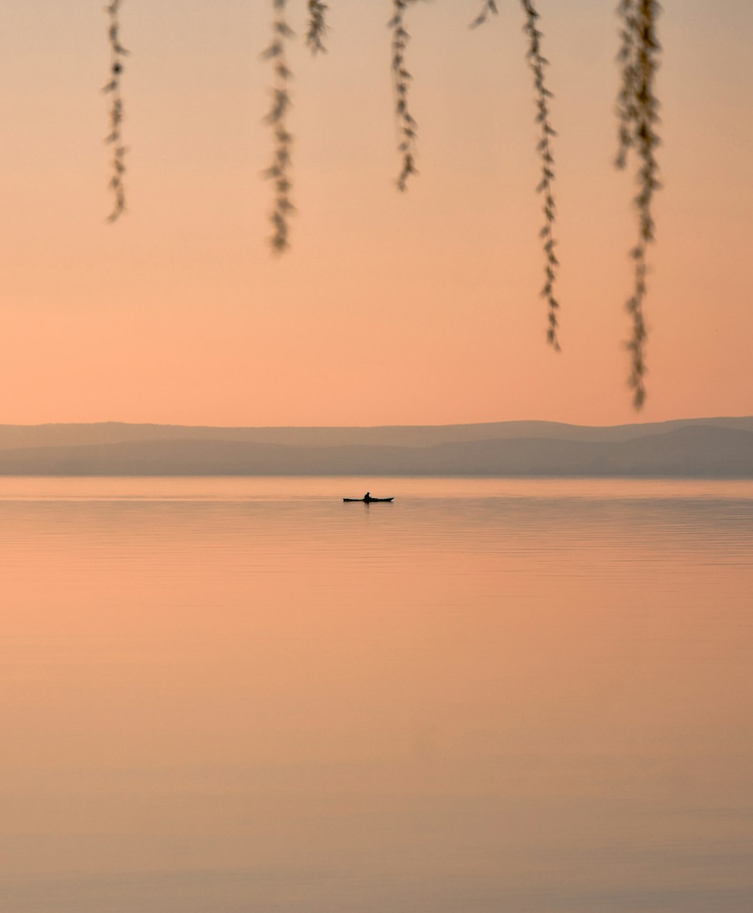 boat on calm body of water during golden hour
