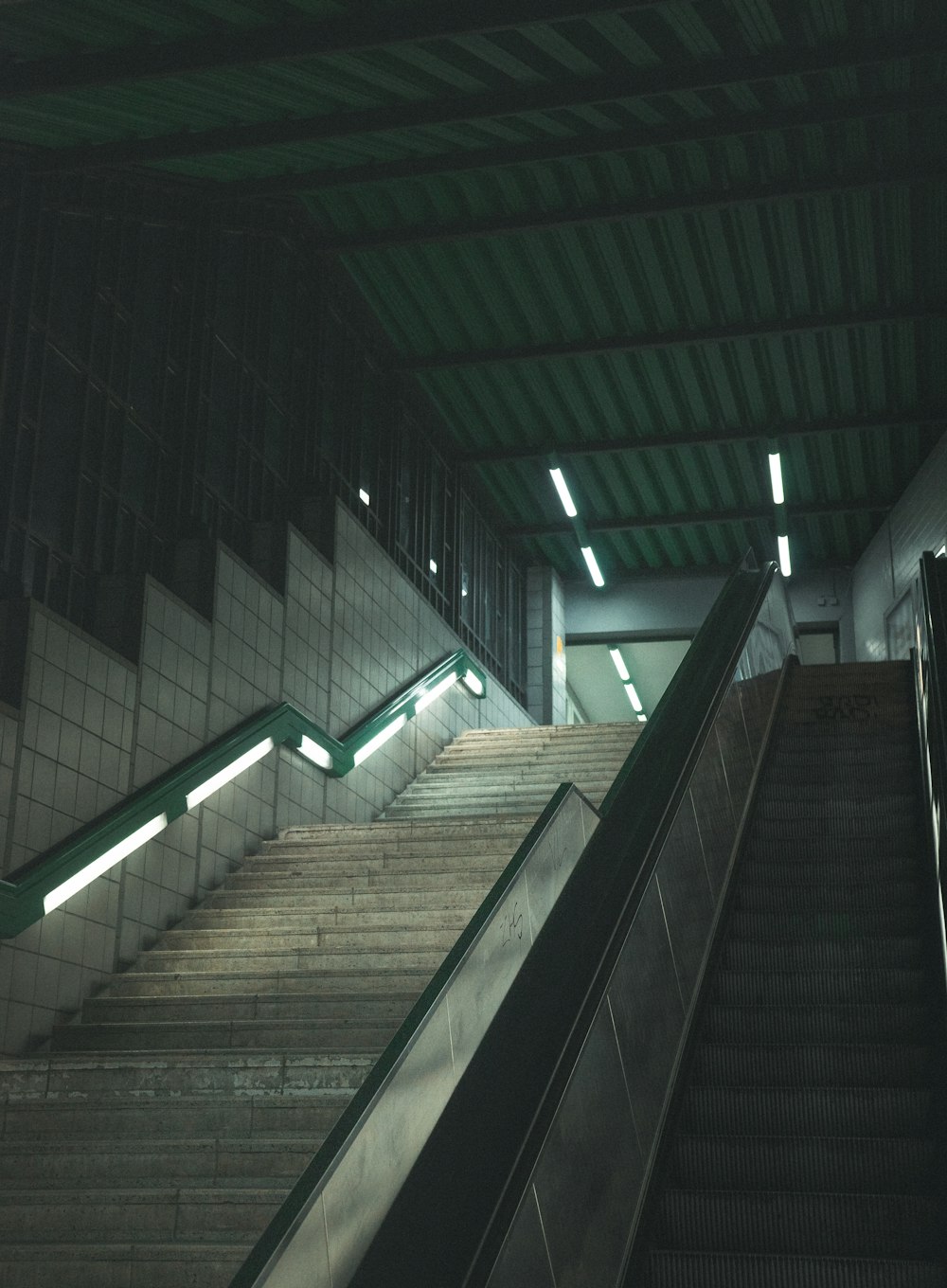 an escalator in a subway station with stairs