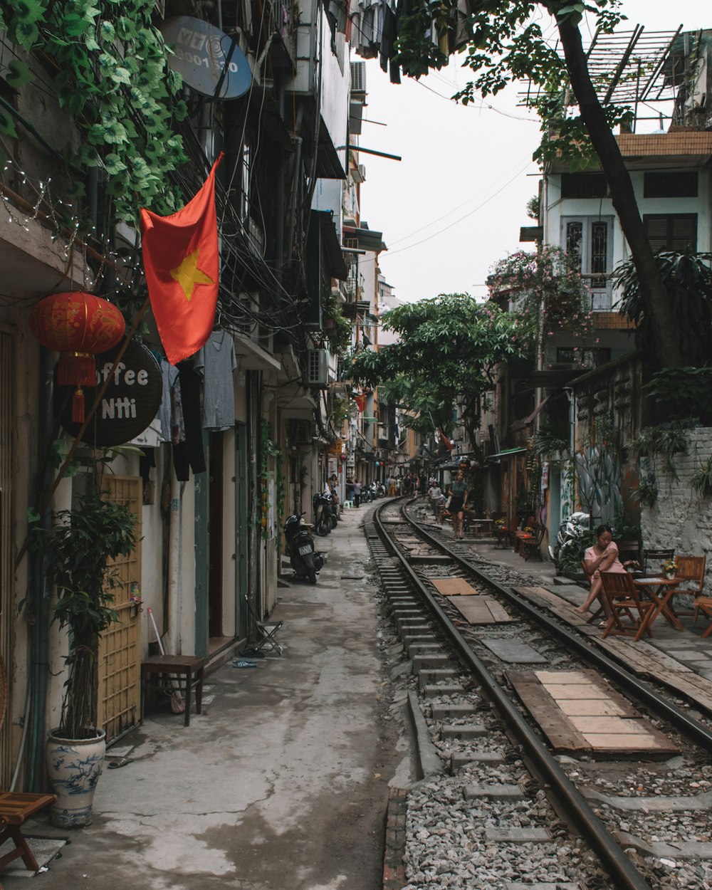 white and gray train tracks near houses