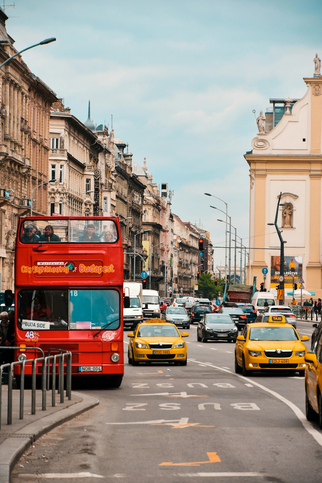 red double decker bus parked side of road