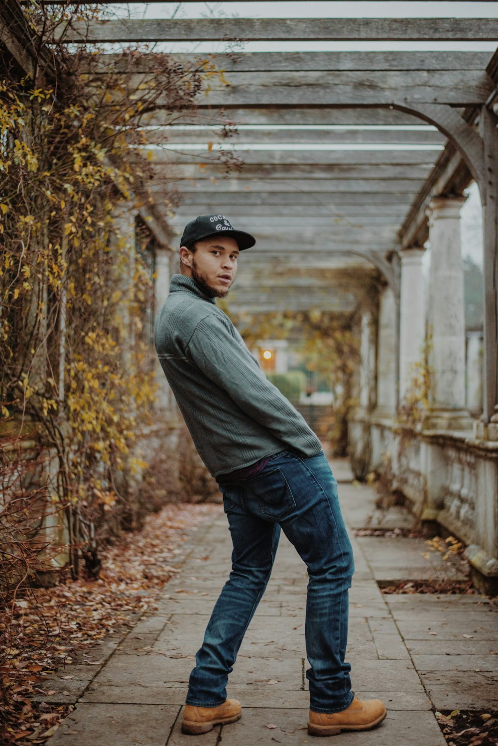 hombre con chaqueta gris y jeans de mezclilla azul al aire libre