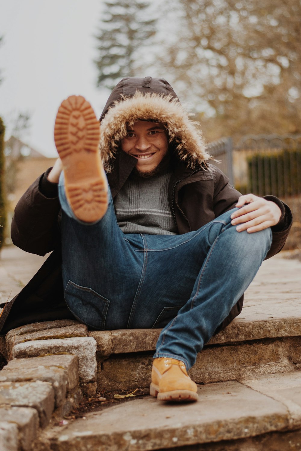 man in grey shirt lifting his right foot