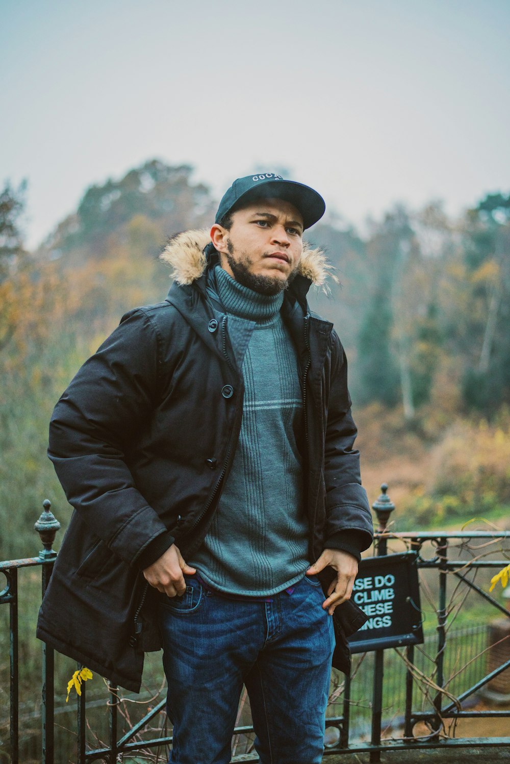 man standing near fence