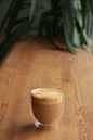 clear glass beverage container on table