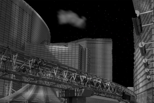 A futuristic cityscape with modern, geometric buildings illuminated against a night sky. A cloud floats above, adding contrast to the metallic and glass structures. An intricate transport track runs across the foreground, contributing to the architectural complexity.