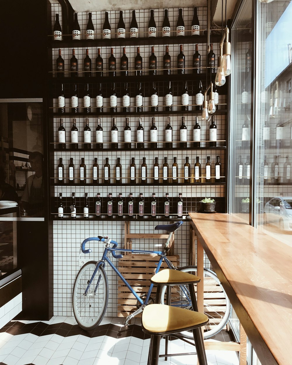 blue and white bicycle leaning on glass wall