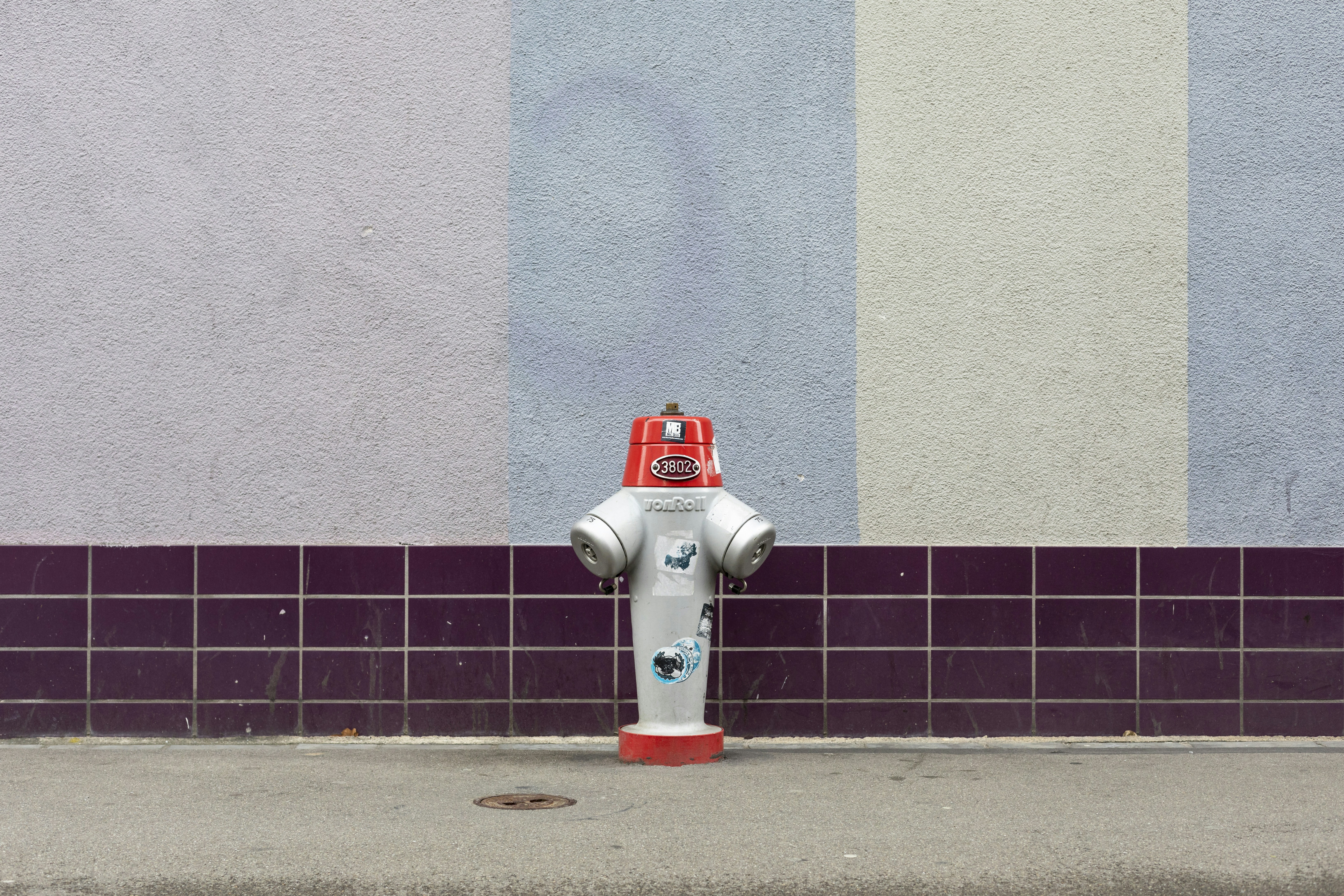 Branimo white and red fire hydrant on sidewalk