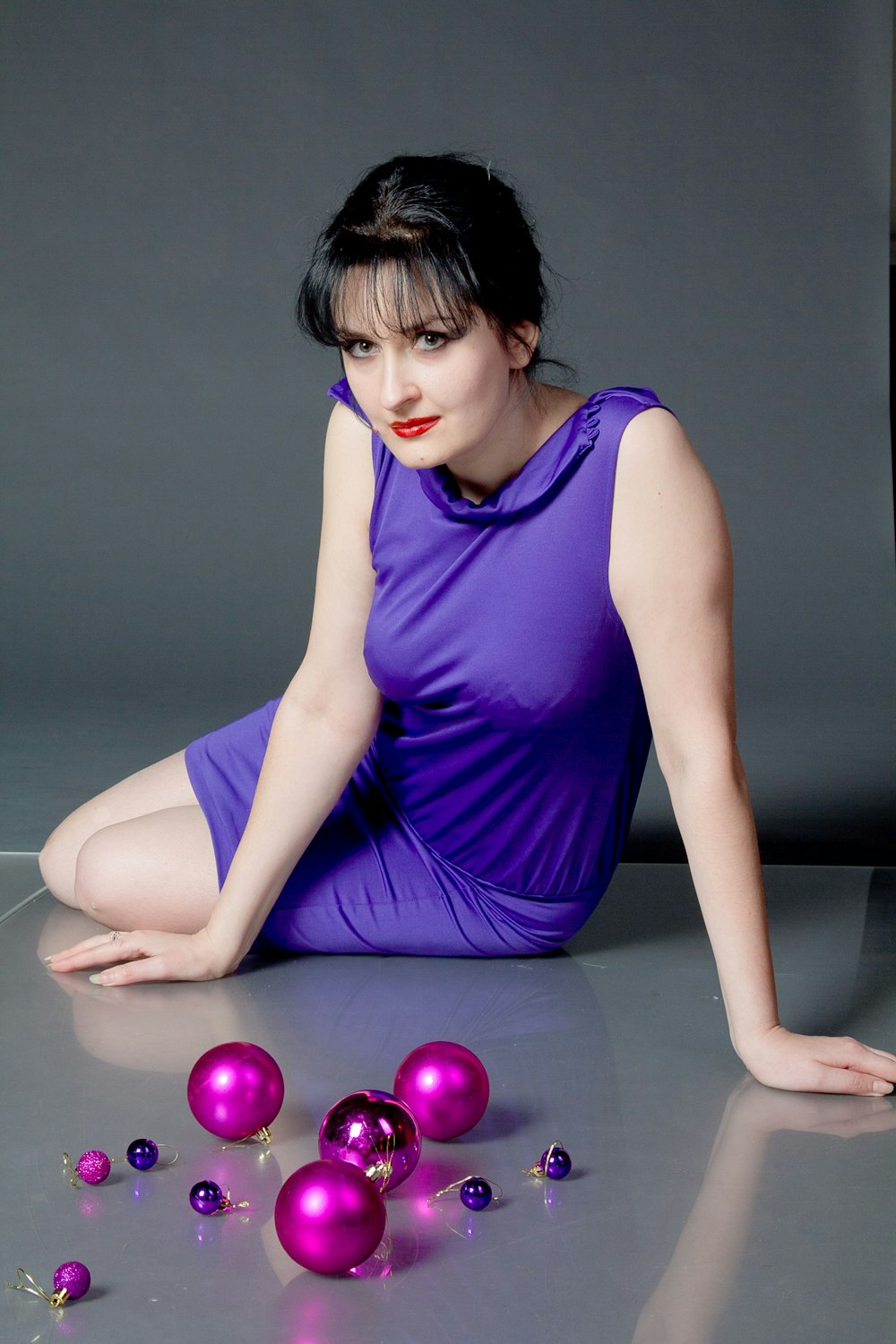 woman sitting on floor in front of baubles