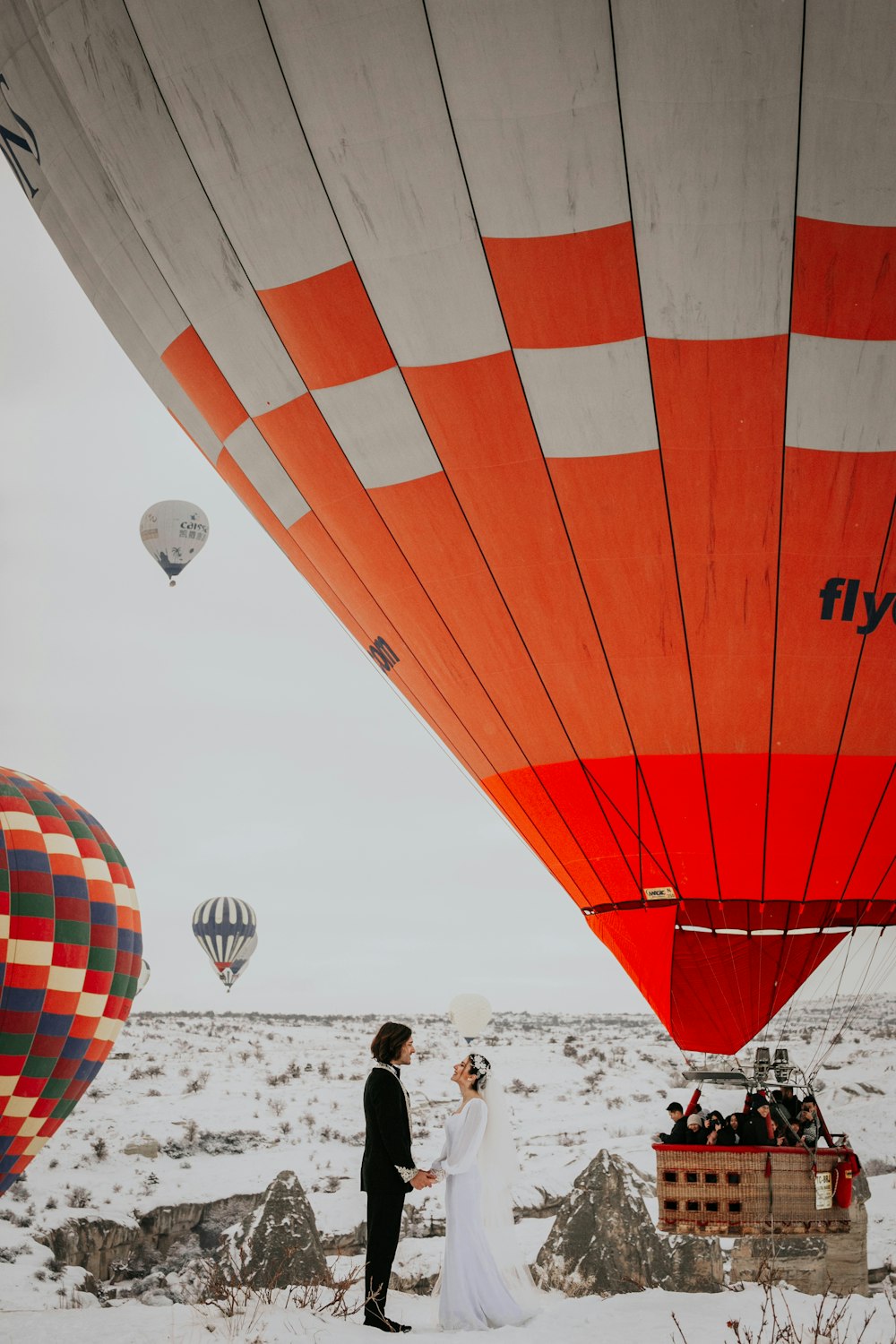 groom and bride near hot air balloons