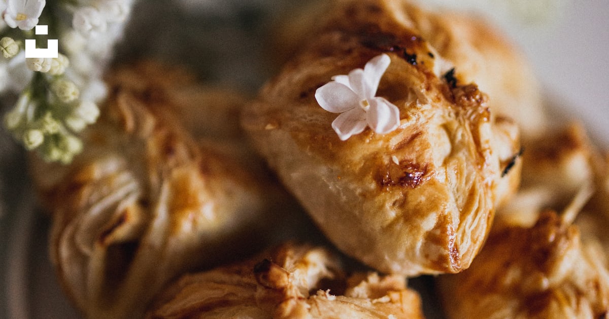 Brown pastries on plated beside white flowers photo – Free Food Image ...