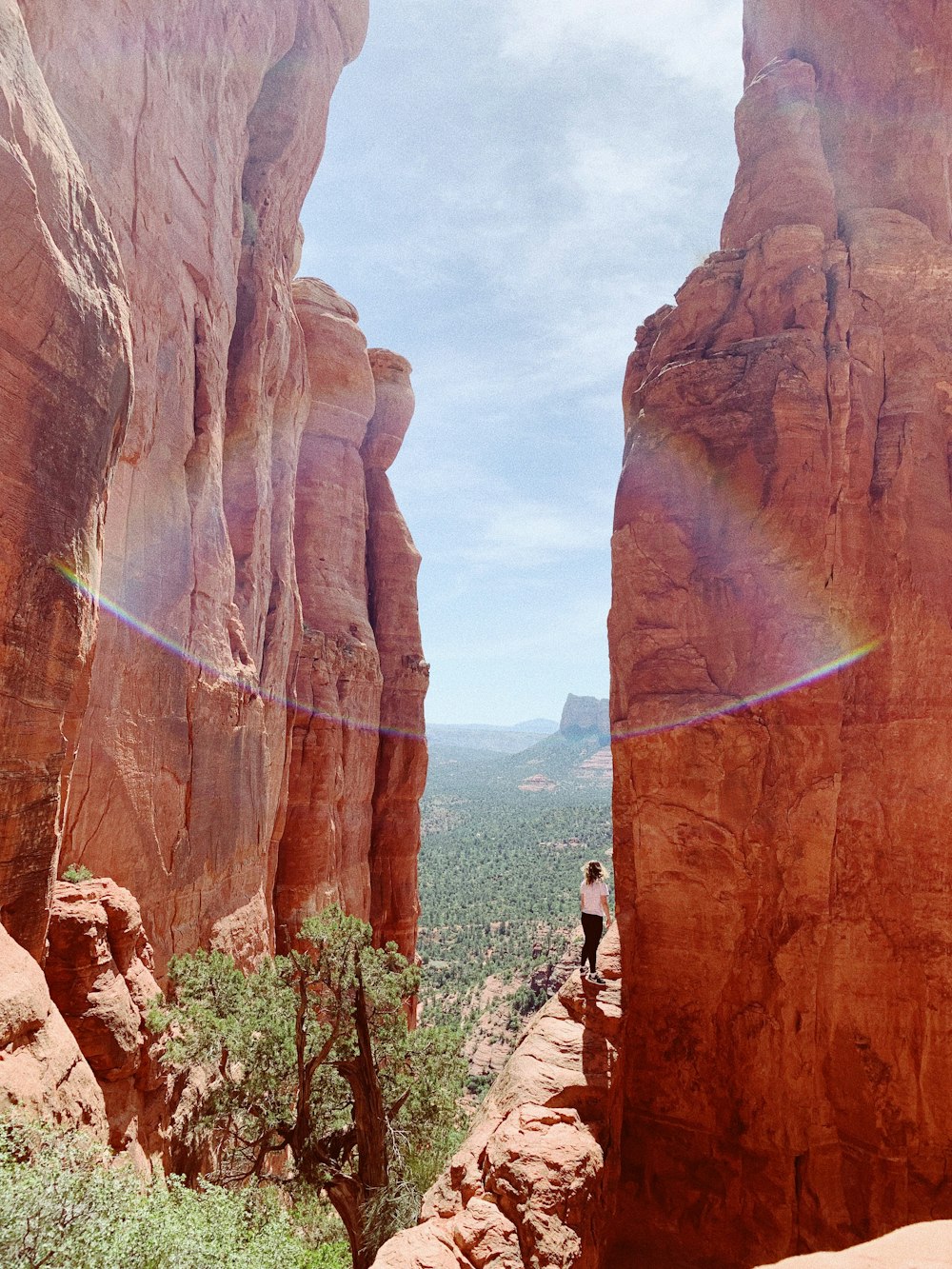 person in a cliff during daytime