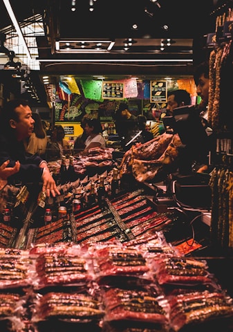 A vibrant market scene showcasing various promotional banners and booths.