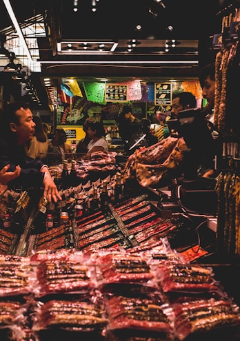 A cozy local market scene showing various handmade product stalls with people interacting warmly.
