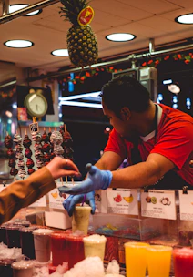 A vibrant farmer handing fresh fruits to a smoothie bar owner in a cozy rustic kitchen.