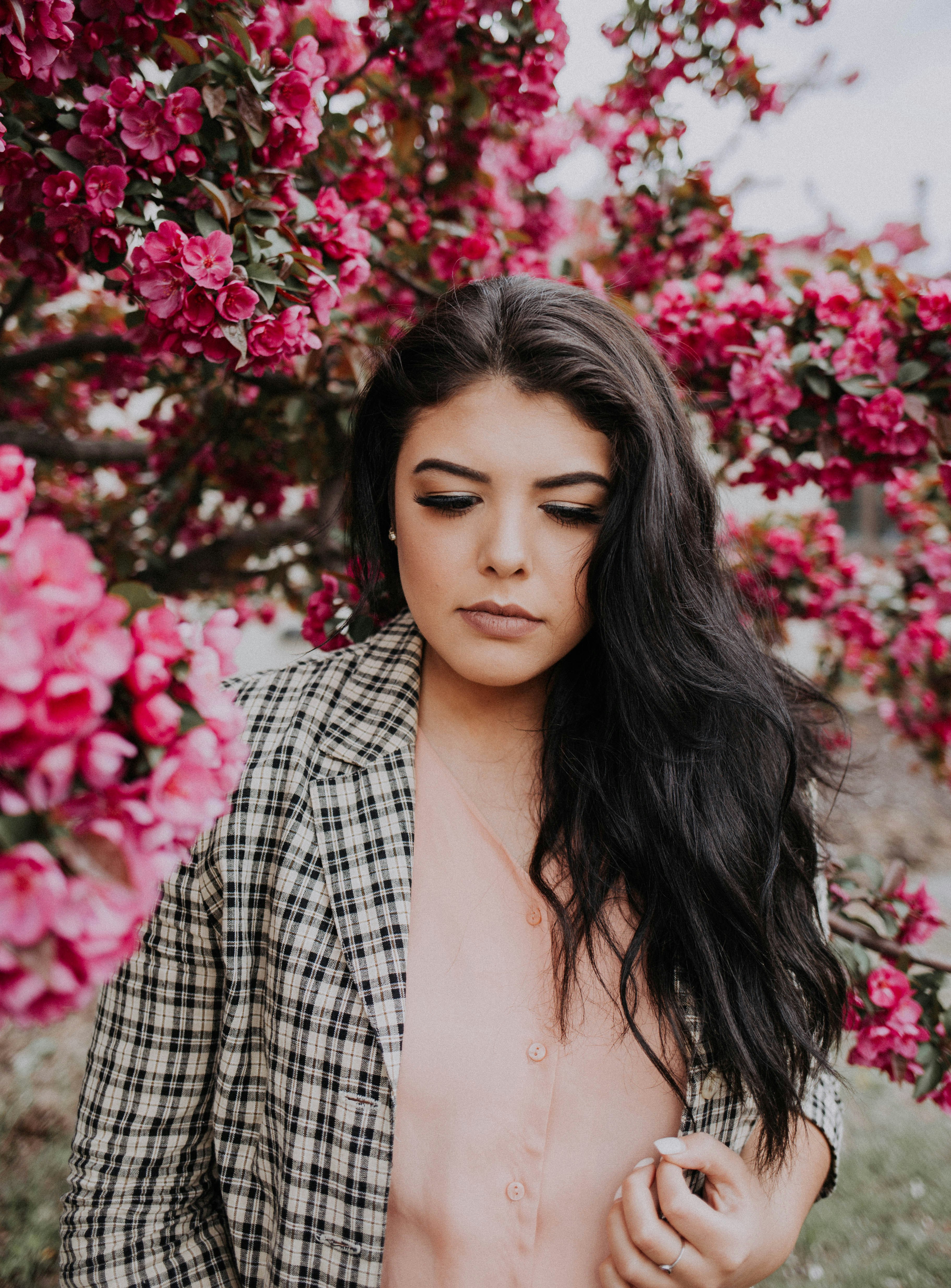 woman standing near pink flowers