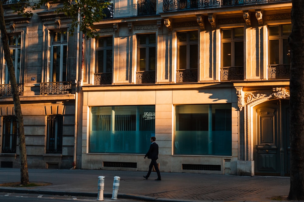 man walking near concrete buildings