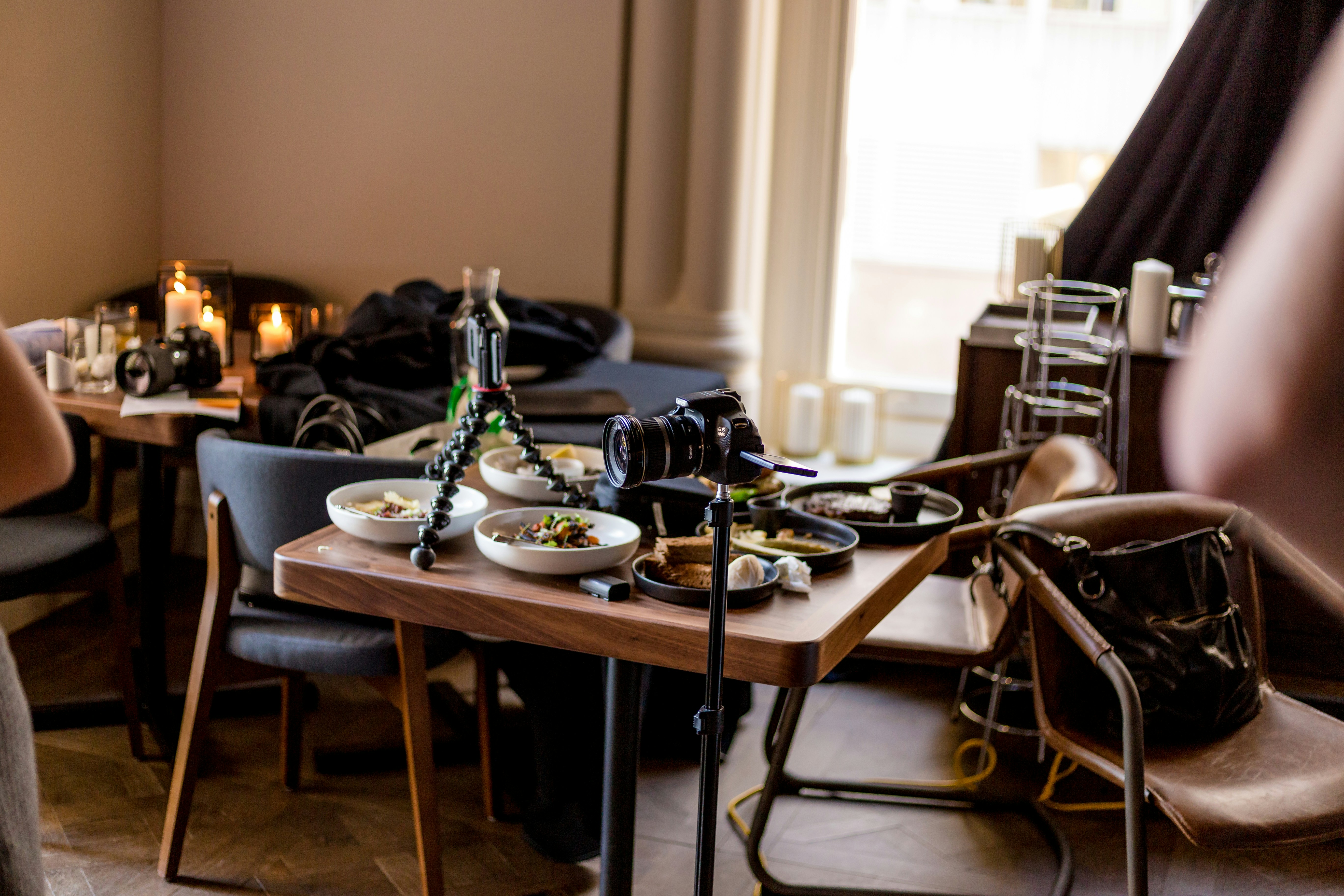 brown table full of food and DLSR camera