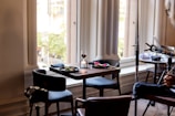 A stylish dining area with a table set for two, perfect for in-room meals.