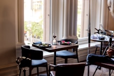 A stylish dining area with a table set for two, perfect for in-room meals.