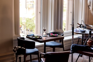 A cozy dining table set for two with gourmet Italian dishes.