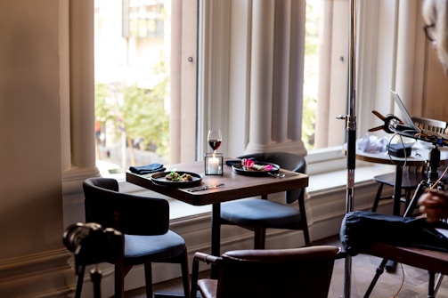 A warmly lit dining table set for two near a window at Aurelia Restaurant.