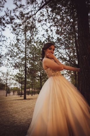 A model posing elegantly in a natural outdoor setting.
