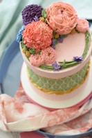 A beautifully decorated custom cake with floral accents.