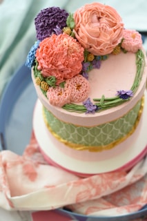 A colorful celebration cake decorated with flowers.