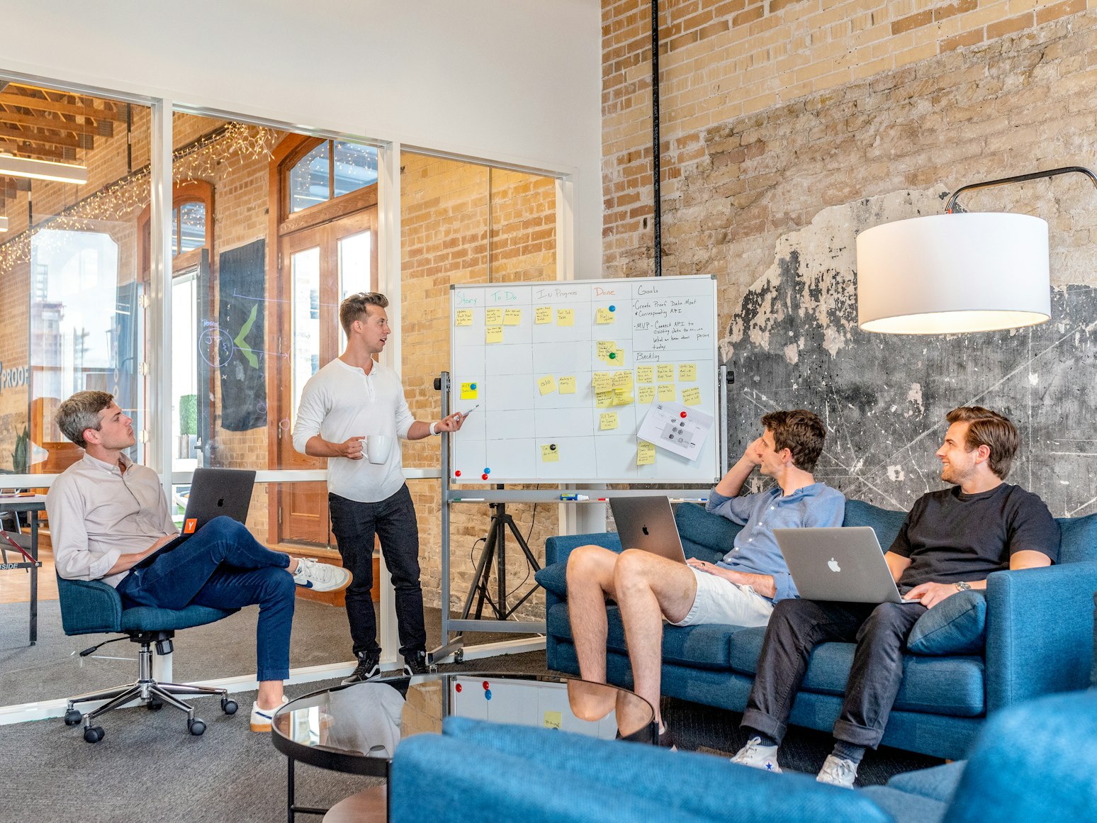  A person holding a team meeting in an office room. 