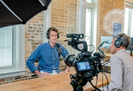 man wearing headphones on set of recording his podcast