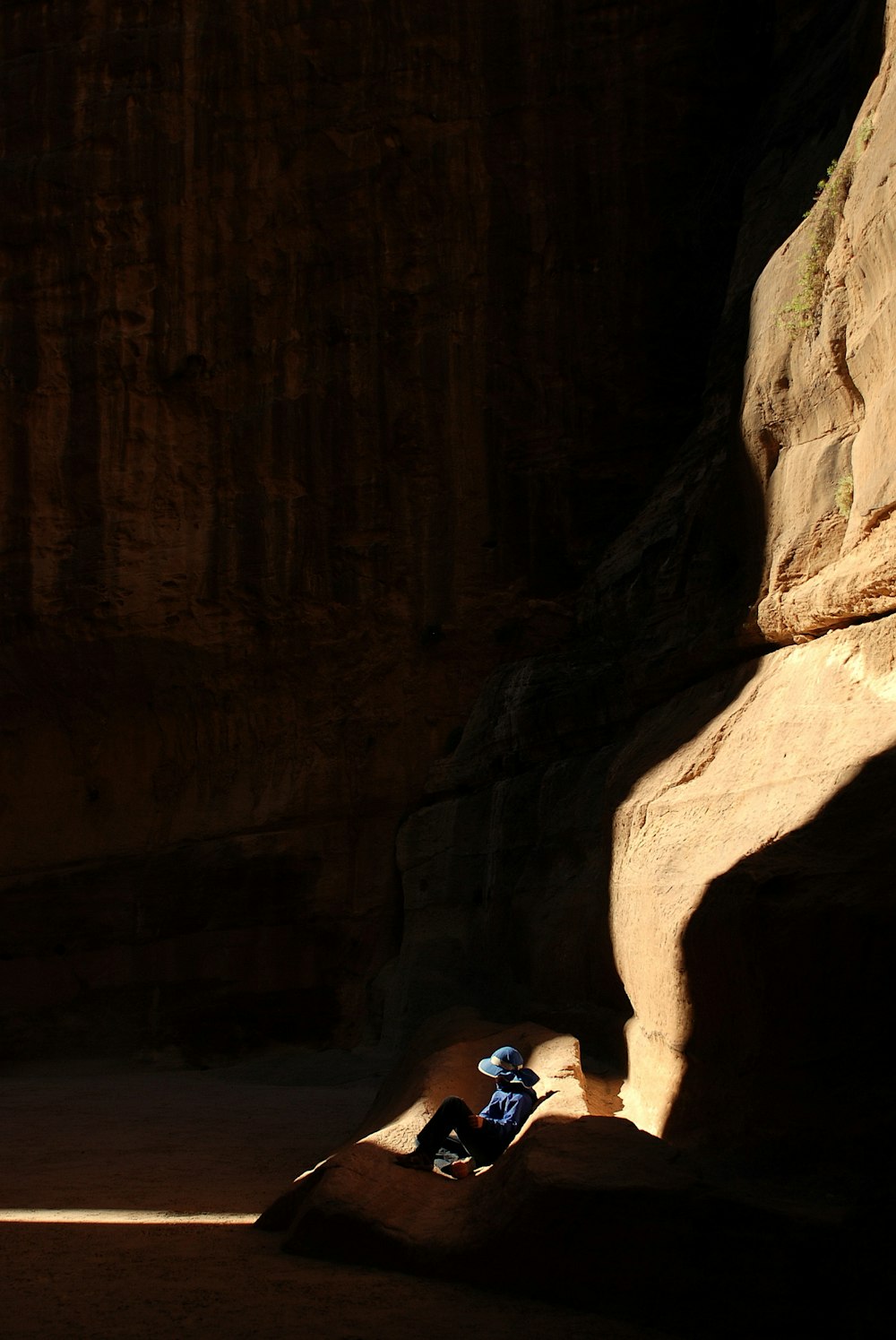 person sitting inside cave