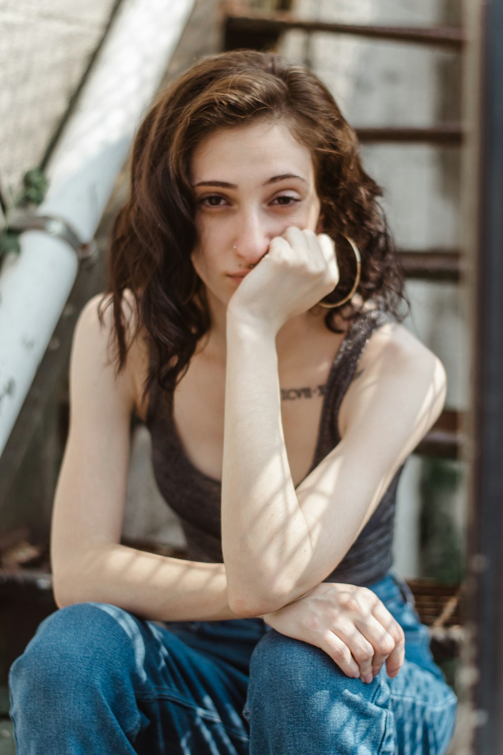 woman sitting and putting left hand on her face