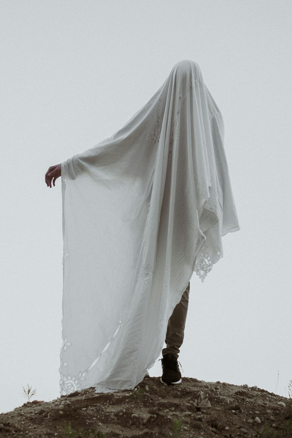 man covered in white cloth